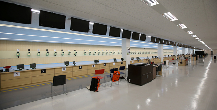 At the indoor shooting range, there are 60 shooting stations ready for athletes to practice the 10 meter, 25 meter and 50 meter pistol events.
