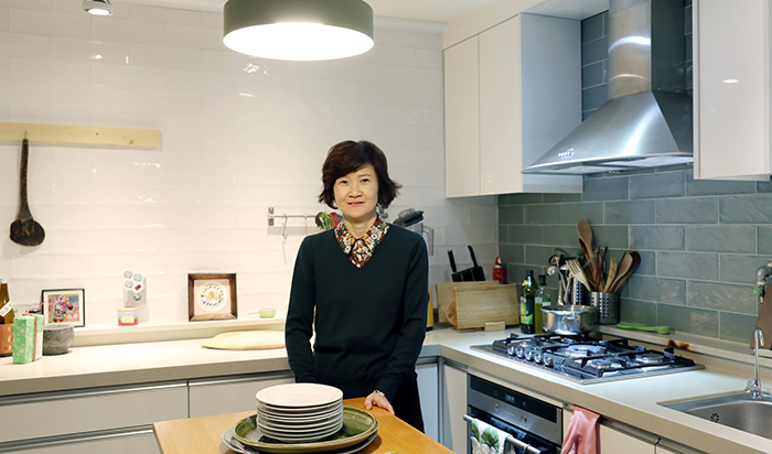 For Hideko Nakagawa, cooking and food are fun and joy in and of themselves. Students come to her classes to learn how to cook and to enjoy the food and conversation. Nakagawa poses for a photo in her kitchen.