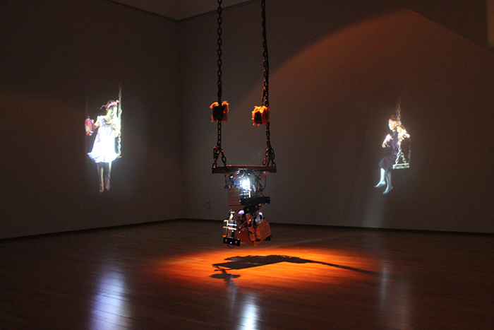 'Jacky’s Swing' is a work of media art that shows an image of a woman talking and playing on a swing, by Kim Youngjin (2006).