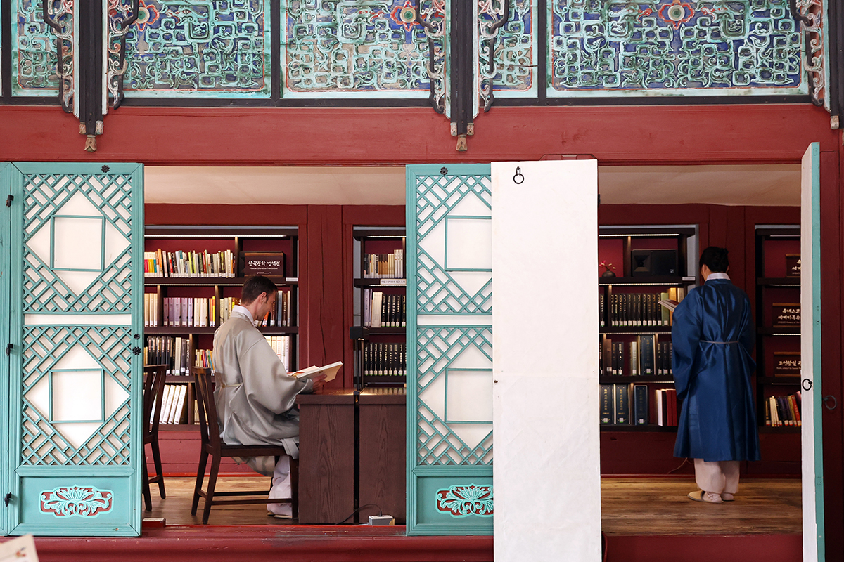 9 апреля иностранные туристы рассматривают книги в павильоне Чибокчэ во дворце Кёнбоккун в Сеуле.